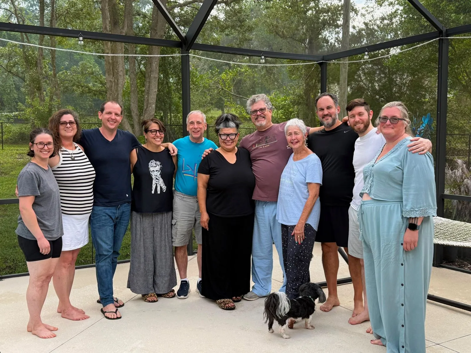 A big family gathering on a screened porch.