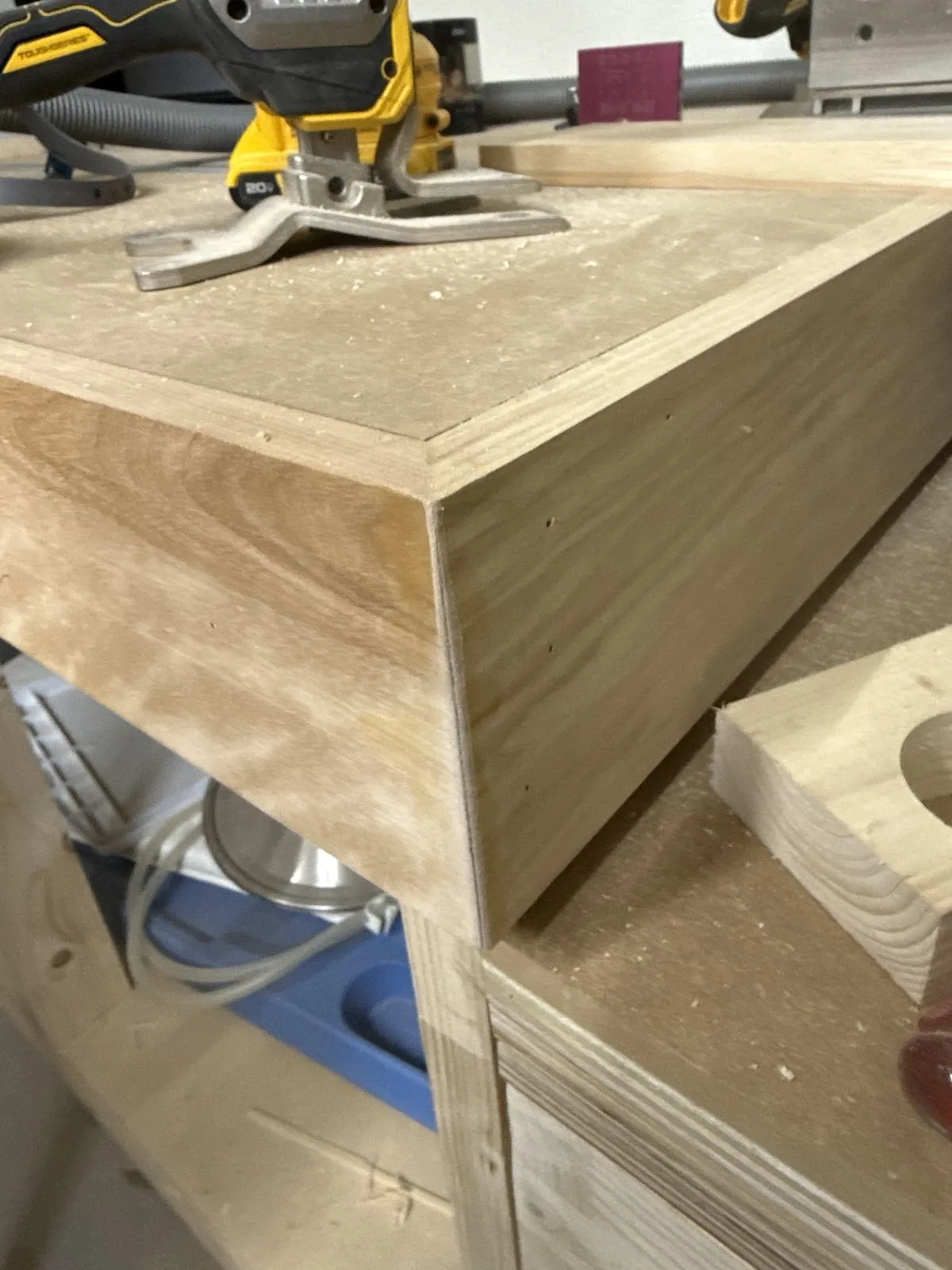 A close-up of a clamped wood joint during a build.