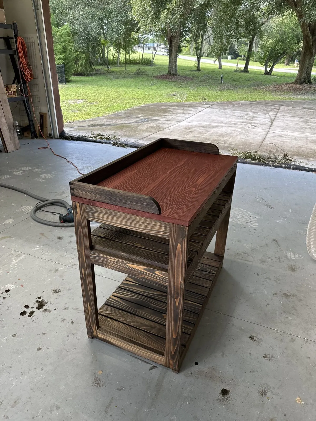 A rustic wooden cart David built, outdoors.