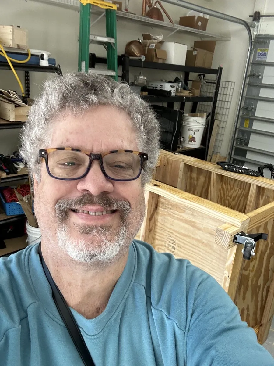 David in his workshop, smiling.